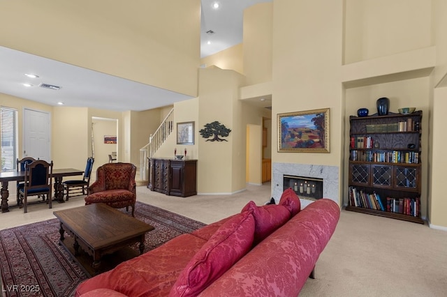 2033 Summer Spruce Pl Unit 102, Las Vegas, NV 89134 - carpeted living room featuring stairs, baseboards, a premium fireplace, and recessed lighting
