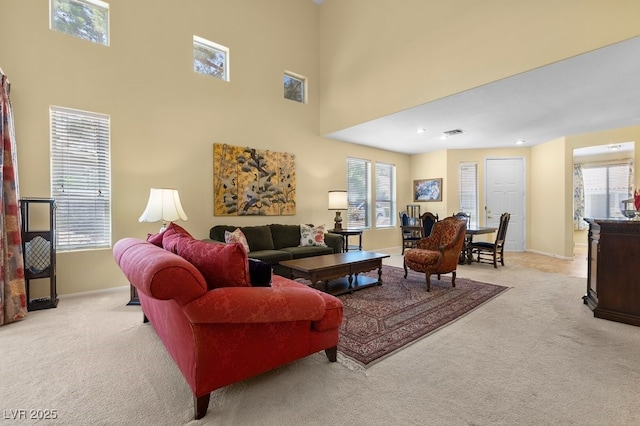 2033 Summer Spruce Pl Unit 102, Las Vegas, NV 89134 - carpeted living area featuring baseboards and a high ceiling