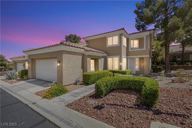 2033 Summer Spruce Pl Unit 102, Las Vegas, NV 89134 - mediterranean / spanish house with stucco siding, a tile roof, an attached garage, and concrete driveway