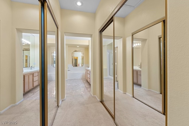 2033 Summer Spruce Pl Unit 102, Las Vegas, NV 89134 - corridor with light colored carpet and a sink