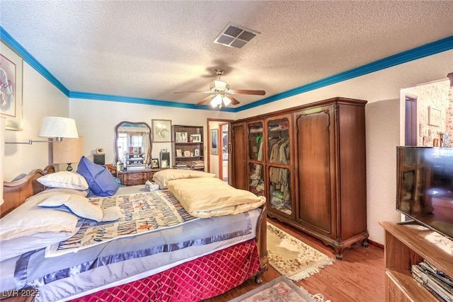 2045 S Tenaya Way, Las Vegas, NV 89117 - bedroom with a textured ceiling, light wood-style floors, crown molding, and a ceiling fan