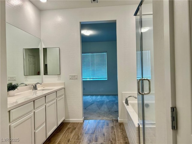 965 Nevada State Dr Unit 39102, Henderson, NV 89002 - full bath with vanity, wood finished floors, a garden tub, and a stall shower
