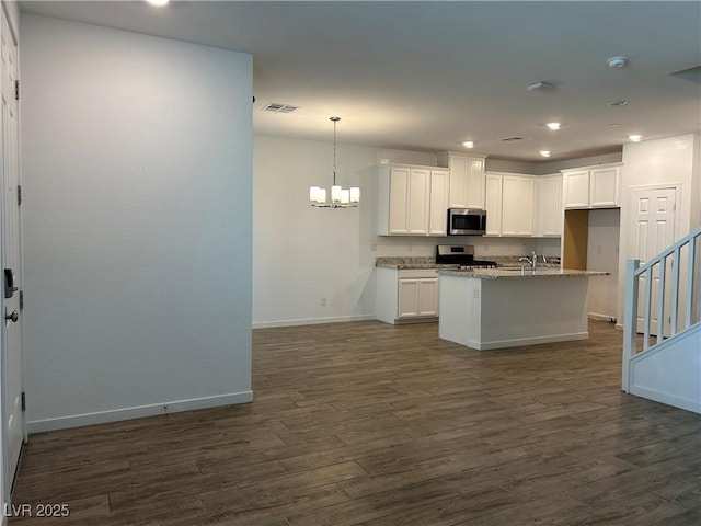965 Nevada State Dr Unit 39102, Henderson, NV 89002 - kitchen featuring stainless steel appliances, a chandelier, dark wood finished floors, light stone countertops, and recessed lighting