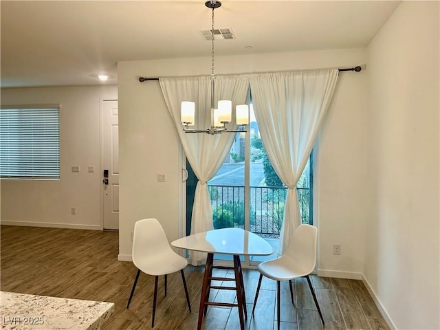 965 Nevada State Dr Unit 39102, Henderson, NV 89002 - dining space featuring a chandelier and wood finished floors