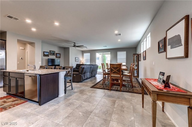 5854 Olivine Falls Ave, Las Vegas, NV 89130 - kitchen with stainless steel appliances, a sink, a ceiling fan, recessed lighting, and dark brown cabinetry