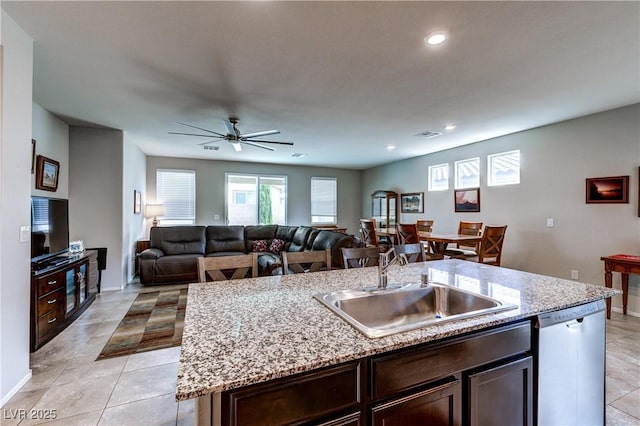 5854 Olivine Falls Ave, Las Vegas, NV 89130 - kitchen with dishwasher, a sink, baseboards, dark brown cabinets, and recessed lighting