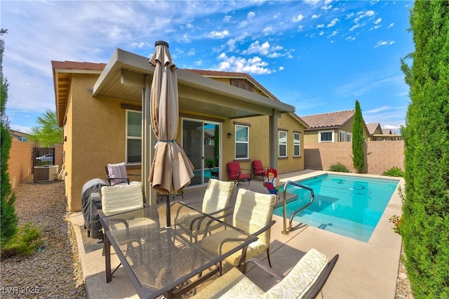 5854 Olivine Falls Ave, Las Vegas, NV 89130 - rear view of property featuring stucco siding, a fenced backyard, a patio, and central AC unit