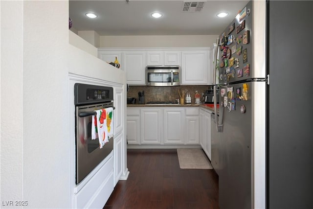 35 E Agate Ave Unit 208, Las Vegas, NV 89123 - kitchen featuring stainless steel appliances, white cabinets, dark wood-style floors, backsplash, and recessed lighting