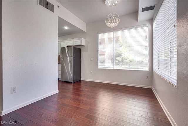 35 E Agate Ave Unit 208, Las Vegas, NV 89123 - unfurnished dining area with dark wood finished floors, a chandelier, and a textured wall