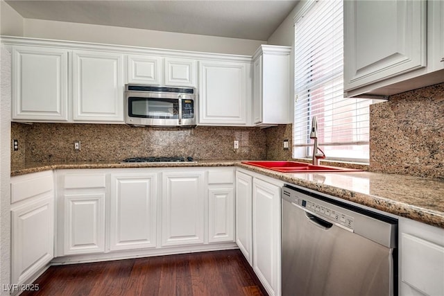 35 E Agate Ave Unit 208, Las Vegas, NV 89123 - kitchen with stainless steel appliances, white cabinets, dark wood-type flooring, and decorative backsplash