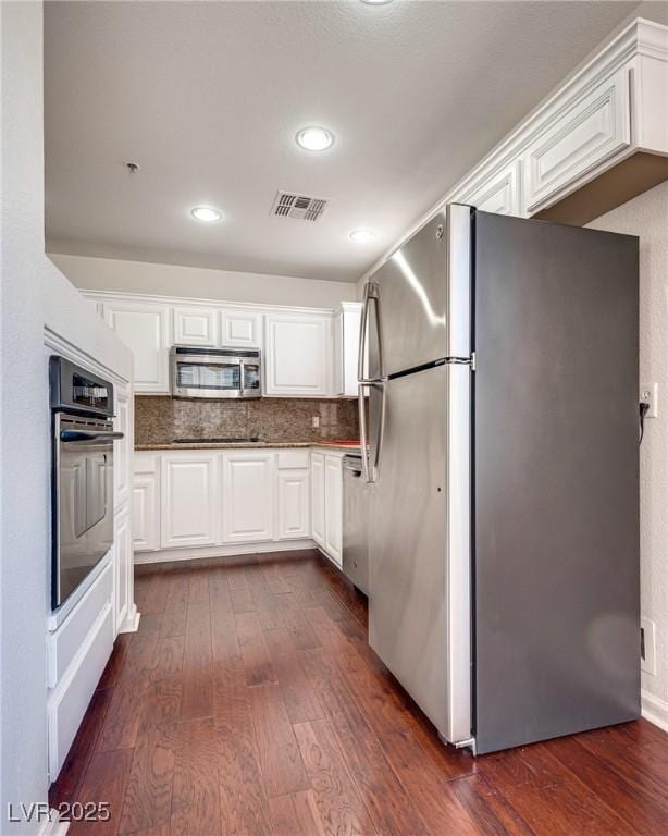 35 E Agate Ave Unit 208, Las Vegas, NV 89123 - kitchen featuring appliances with stainless steel finishes, dark wood-type flooring, white cabinets, backsplash, and recessed lighting
