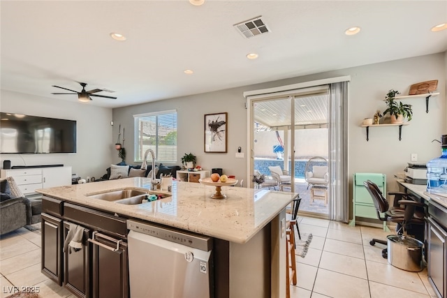 7761 Sagamore Bay Ct, Las Vegas, NV 89179 - kitchen featuring stainless steel dishwasher, a sink, open floor plan, light tile patterned flooring, and recessed lighting