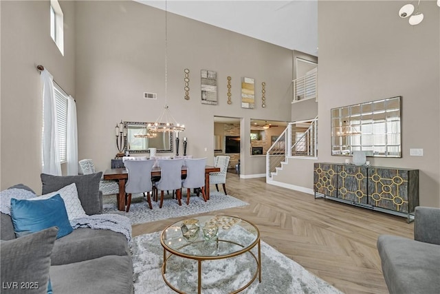 1780 Crystal Stream Ave, Henderson, NV 89012 - living area featuring a high ceiling, a chandelier, and stairway