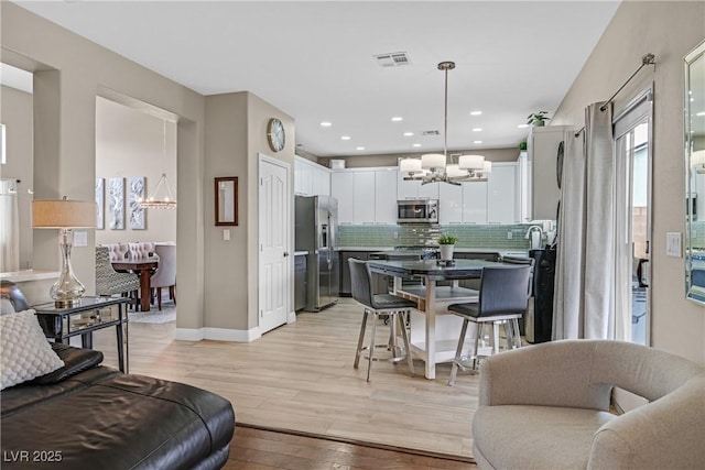 1780 Crystal Stream Ave, Henderson, NV 89012 - living area with a chandelier, light wood finished floors, and recessed lighting
