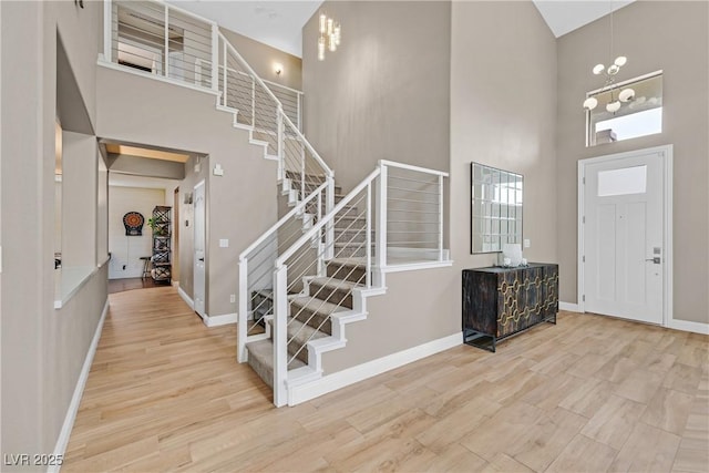 1780 Crystal Stream Ave, Henderson, NV 89012 - entrance foyer with a high ceiling, stairway, wood finished floors, and a chandelier
