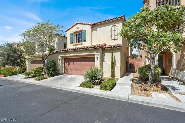 9869 Lime Tree St, Las Vegas, NV 89178 - mediterranean / spanish-style home with stucco siding, a tiled roof, an attached garage, and driveway
