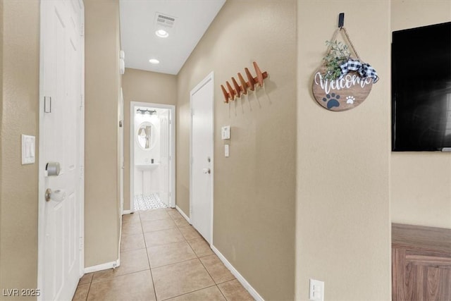 9869 Lime Tree St, Las Vegas, NV 89178 - corridor with light tile patterned floors and baseboards