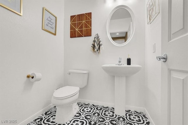 9869 Lime Tree St, Las Vegas, NV 89178 - half bath with toilet, baseboards, tile patterned floors, and a sink