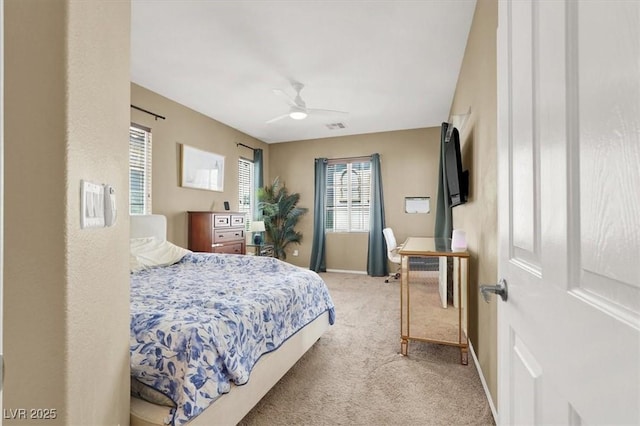 9869 Lime Tree St, Las Vegas, NV 89178 - bedroom with light colored carpet, baseboards, and a ceiling fan