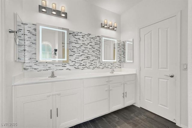 9869 Lime Tree St, Las Vegas, NV 89178 - bathroom with double vanity, decorative backsplash, and wood finished floors
