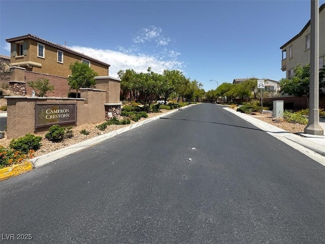 9869 Lime Tree St, Las Vegas, NV 89178 - view of asphalt road with curbs, street lights, and a residential view