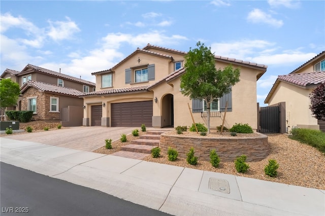 2575 Hazelburn Ave, Henderson, NV 89044 - mediterranean / spanish house featuring an attached garage, stucco siding, driveway, and a tiled roof