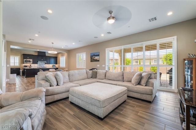 2575 Hazelburn Ave, Henderson, NV 89044 - living area with a ceiling fan, recessed lighting, healthy amount of natural light, and wood tiled floors