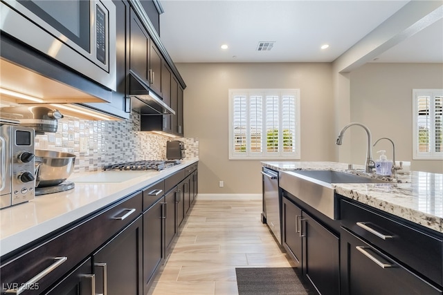 2575 Hazelburn Ave, Henderson, NV 89044 - kitchen with a sink, appliances with stainless steel finishes, under cabinet range hood, healthy amount of natural light, and recessed lighting