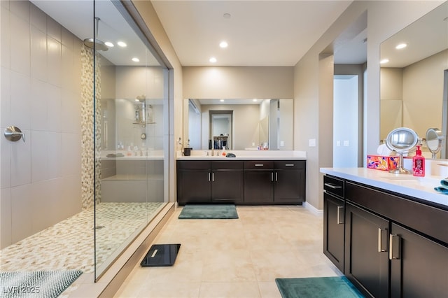 2575 Hazelburn Ave, Henderson, NV 89044 - full bathroom with tiled shower, two vanities, tile patterned floors, recessed lighting, and baseboards