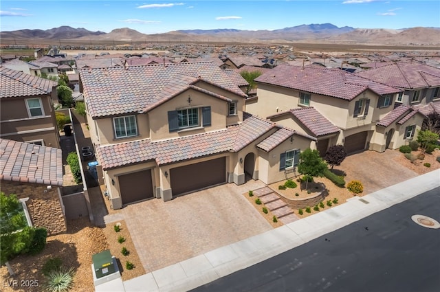 2575 Hazelburn Ave, Henderson, NV 89044 - mediterranean / spanish-style home featuring a residential view, stucco siding, decorative driveway, a tiled roof, and a garage