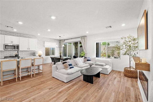 11652 Desert Hollow Ave, Las Vegas, NV 89138 - living area with recessed lighting, light wood finished floors, baseboards, and a chandelier