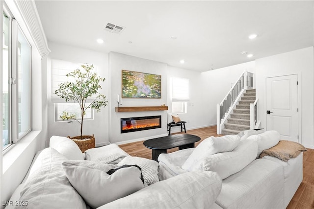 11652 Desert Hollow Ave, Las Vegas, NV 89138 - living room with a glass covered fireplace, recessed lighting, wood finished floors, and stairs