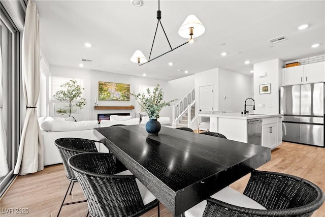 11652 Desert Hollow Ave, Las Vegas, NV 89138 - dining space with stairway, light wood finished floors, recessed lighting, and a chandelier
