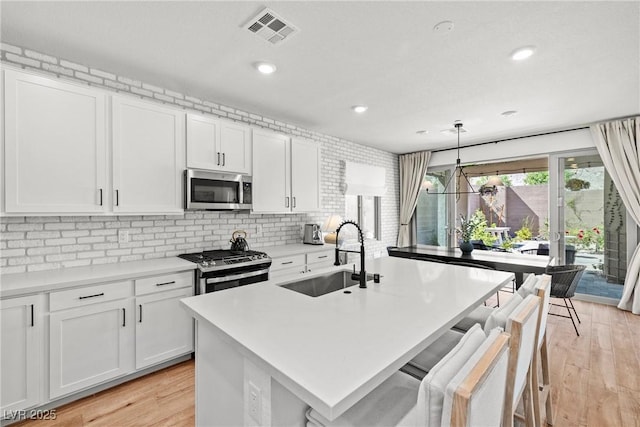 11652 Desert Hollow Ave, Las Vegas, NV 89138 - kitchen with appliances with stainless steel finishes, a sink, white cabinetry, light countertops, and recessed lighting
