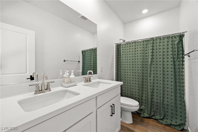 11652 Desert Hollow Ave, Las Vegas, NV 89138 - bathroom with wood finished floors, toilet, double vanity, and a shower with shower curtain