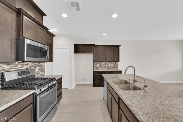 367 Wilford Springs St, Henderson, NV 89014 - kitchen featuring stainless steel appliances, a sink, tasteful backsplash, baseboards, and recessed lighting