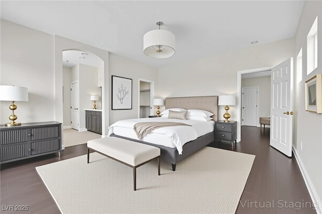 367 Wilford Springs St, Henderson, NV 89014 - bedroom featuring wood finished floors, arched walkways, baseboards, and ensuite bathroom