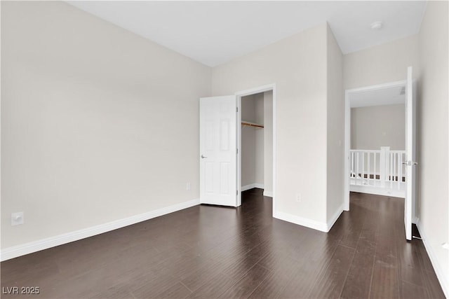 367 Wilford Springs St, Henderson, NV 89014 - unfurnished bedroom with wood finished floors, a closet, a spacious closet, and baseboards