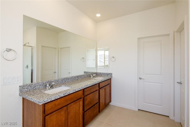 89 Via Franello, Henderson, NV 89011 - full bath featuring double vanity, tile patterned floors, an enclosed shower, and baseboards