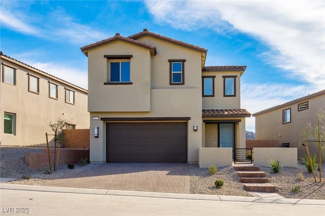 89 Via Franello, Henderson, NV 89011 - view of front facade featuring a tile roof, a garage, stucco siding, and decorative driveway