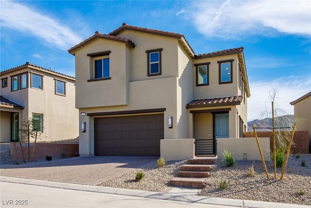 89 Via Franello, Henderson, NV 89011 - mediterranean / spanish home with a tiled roof, an attached garage, stucco siding, and driveway