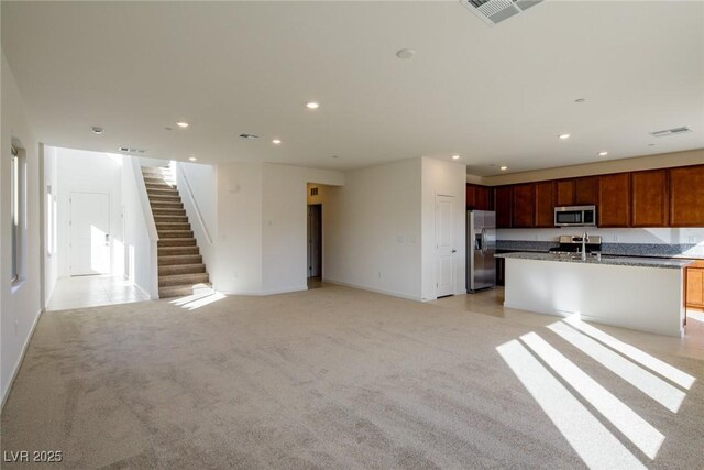 89 Via Franello, Henderson, NV 89011 - unfurnished living room with a sink, light carpet, stairway, recessed lighting, and baseboards