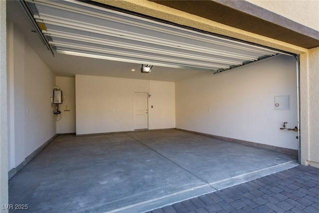 89 Via Franello, Henderson, NV 89011 - garage featuring a garage door opener, water heater, and baseboards