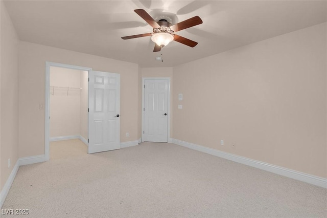 1312 Fragrant Spruce Ave, Las Vegas, NV 89123 - unfurnished bedroom featuring light carpet, baseboards, a walk in closet, and ceiling fan