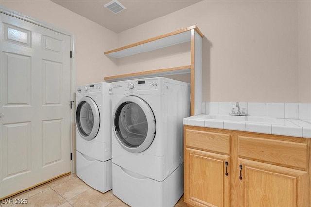 1312 Fragrant Spruce Ave, Las Vegas, NV 89123 - washroom with washing machine and clothes dryer, cabinet space, and light tile patterned floors
