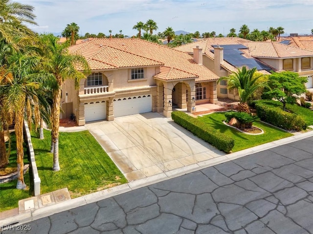 1312 Fragrant Spruce Ave, Las Vegas, NV 89123 - mediterranean / spanish-style house featuring stucco siding, a tiled roof, an attached garage, roof mounted solar panels, and driveway