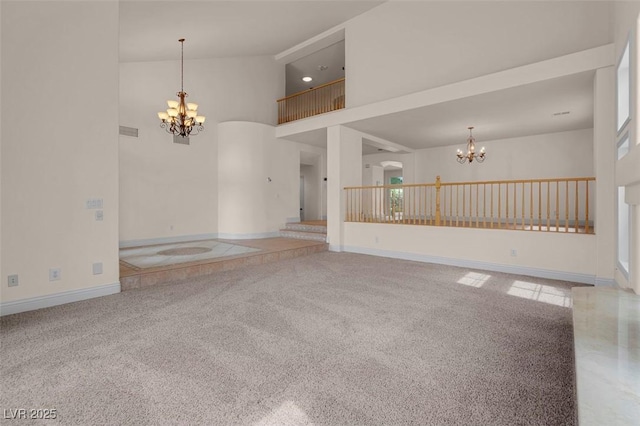 1312 Fragrant Spruce Ave, Las Vegas, NV 89123 - unfurnished living room featuring a chandelier, a towering ceiling, carpet floors, and baseboards