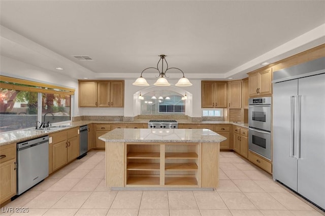 1312 Fragrant Spruce Ave, Las Vegas, NV 89123 - kitchen featuring appliances with stainless steel finishes, a sink, a kitchen island, light tile patterned floors, and healthy amount of natural light