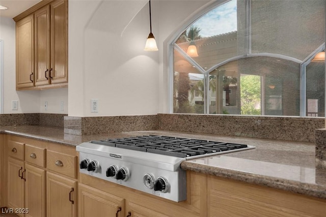 1312 Fragrant Spruce Ave, Las Vegas, NV 89123 - kitchen with stainless steel gas stovetop, light stone counters, and decorative light fixtures