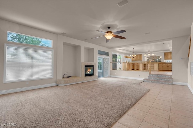1312 Fragrant Spruce Ave, Las Vegas, NV 89123 - unfurnished living room featuring a chandelier, baseboards, a tiled fireplace, light tile patterned flooring, and a ceiling fan